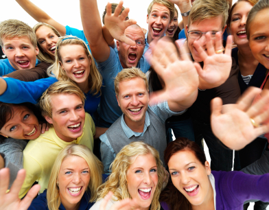 happy men and women with hands raised